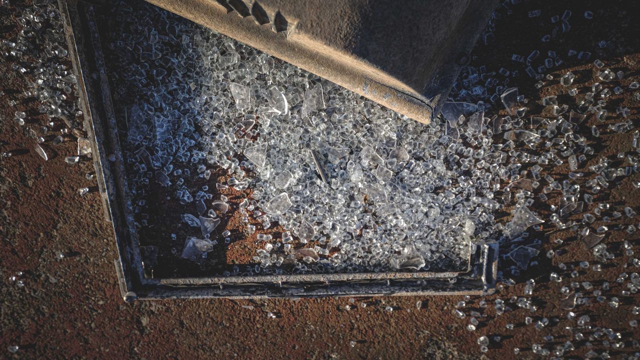 Broken glass fragments that need careful cleanup and disposal