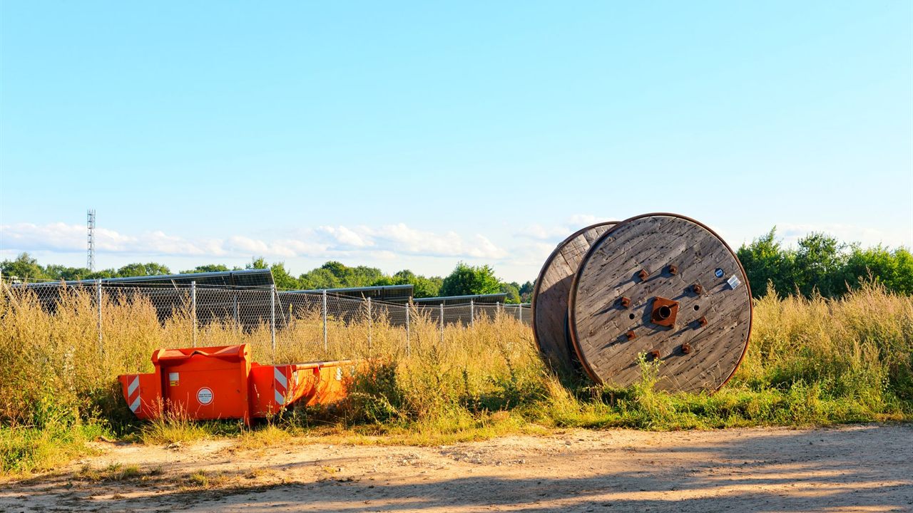 Large wooden cable reel standing on a job site