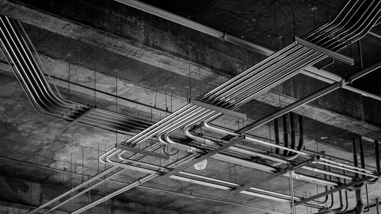 Conduit runs on a ceiling, where bundled PoE cables share space and heat