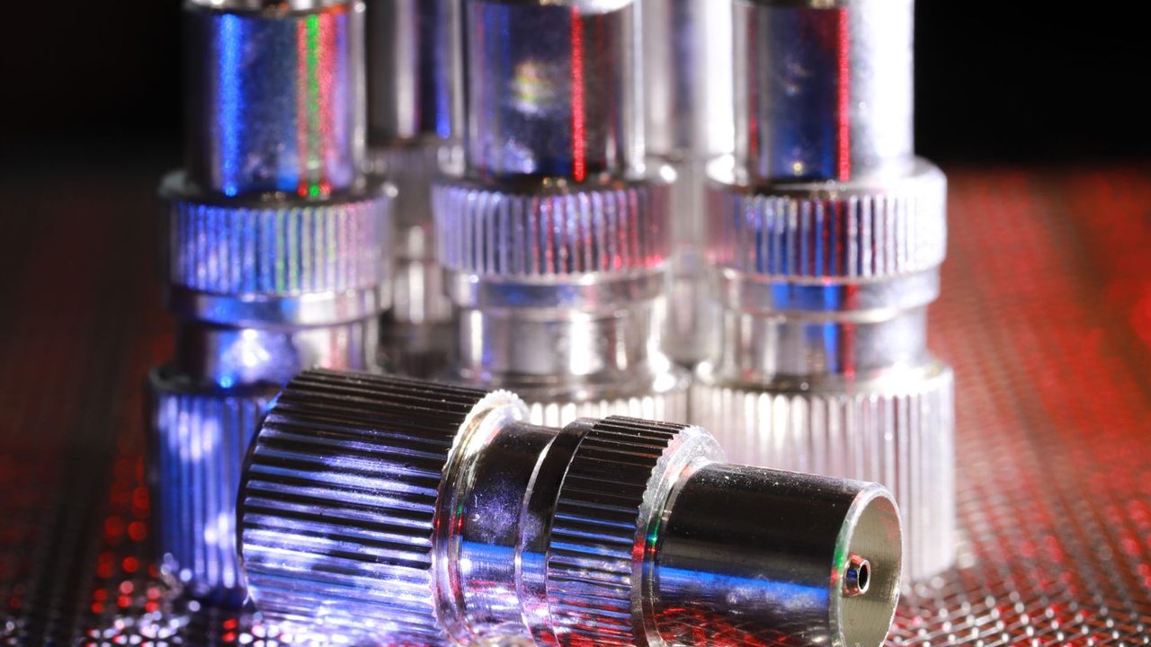 Chrome plated coaxial TV connectors on a metal mesh surface