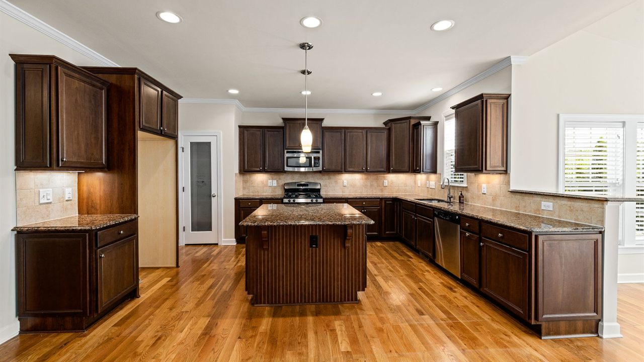 Kitchen ceiling with a grid of recessed lights that speakers must line up with