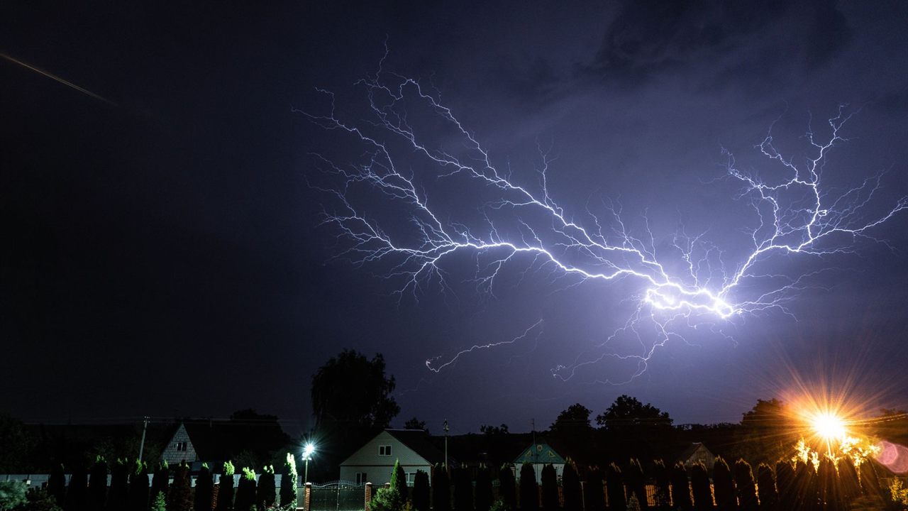 Lightning strike over a residential area, a common source of power surges