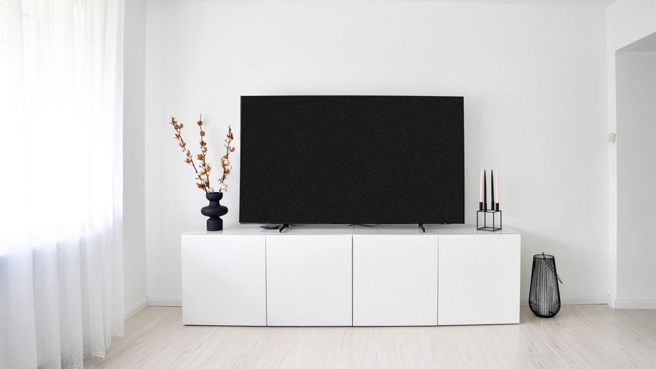 Living room media console with closed cabinet doors that hide AV equipment