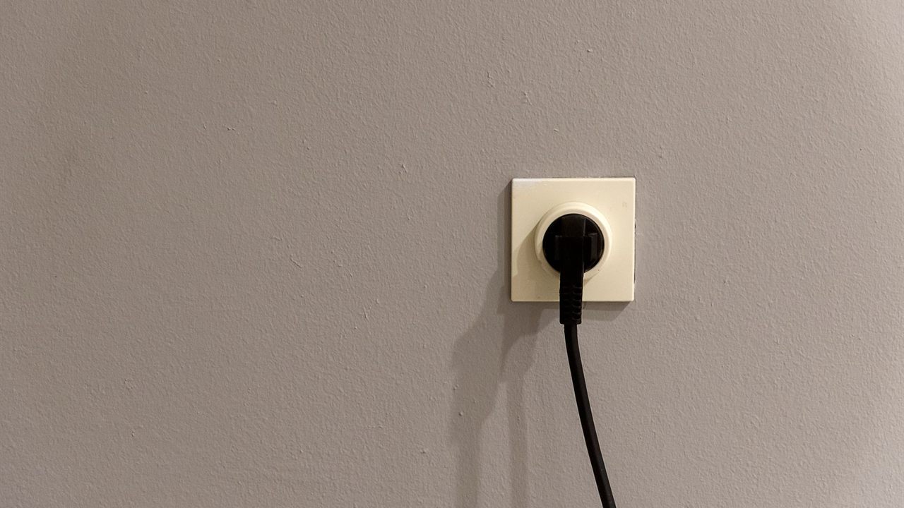 Power cord plugged into a wall receptacle that feeds AV equipment