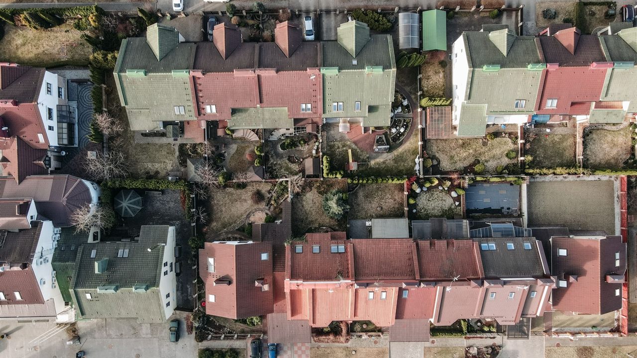 Aerial view of suburban rooftops, where antenna height above the roofline decides off-air reception