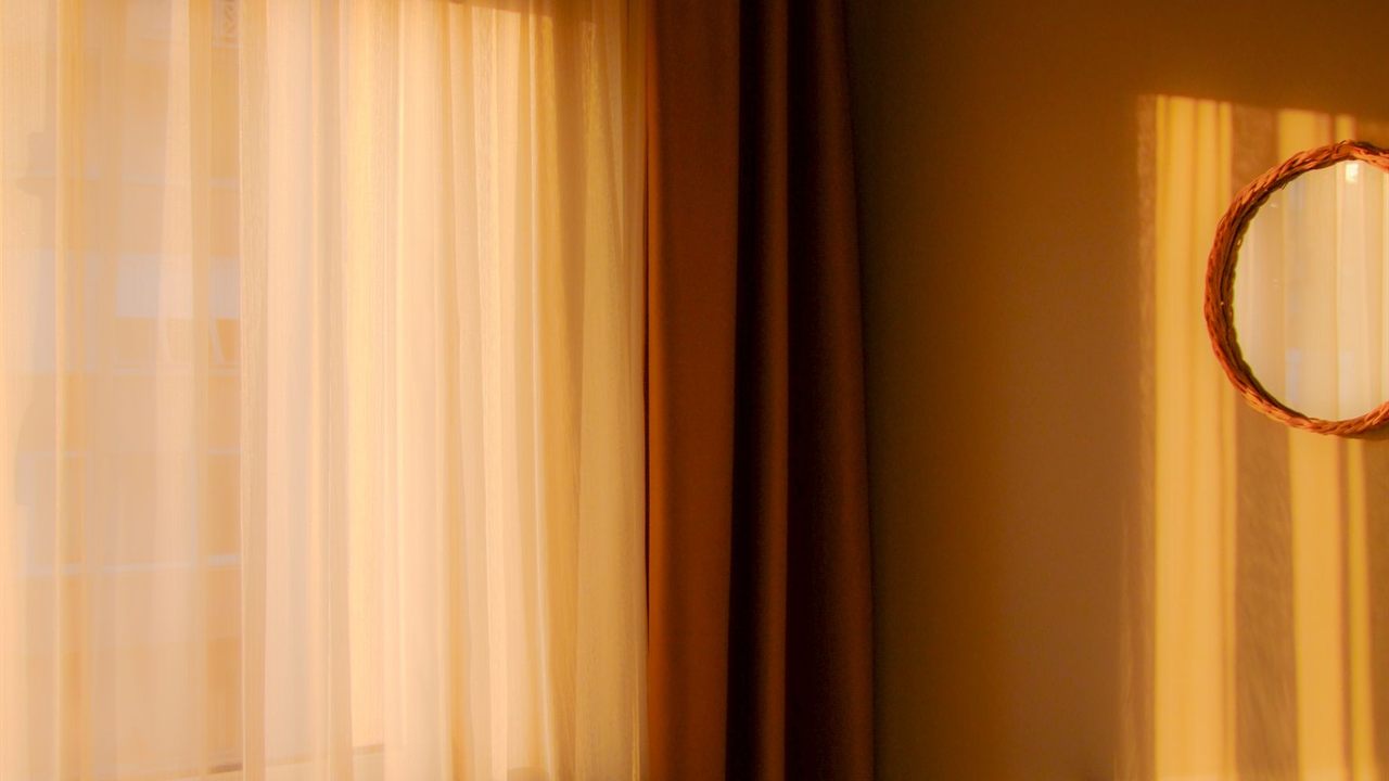 Bright sunlight streaming through a living room window