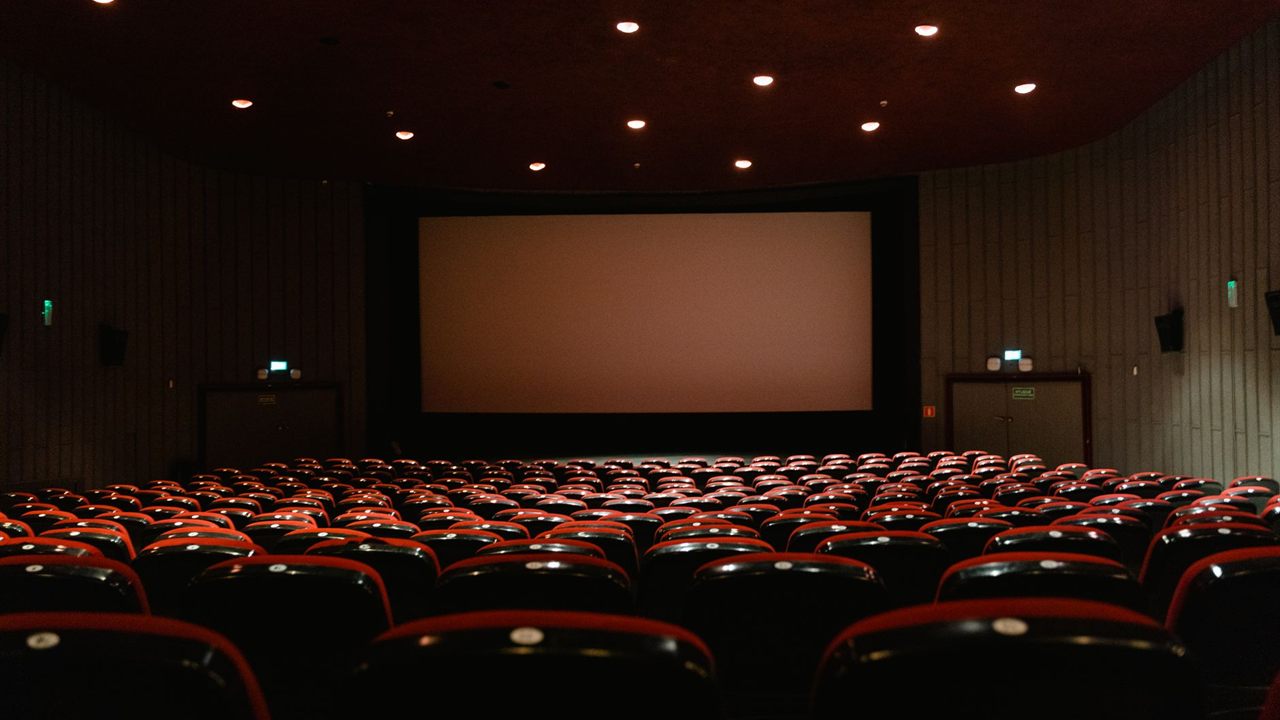 Darkened theater with a large projection screen, an AV system that depends on protected power